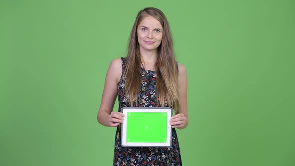 Young Happy Pregnant Woman Showing Digital Tablet