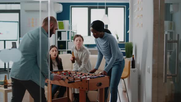 Woman Winning Game of Soccer at Foosball Table