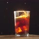 Cola glass with ice cube splash in slow motion - VideoHive Item for Sale