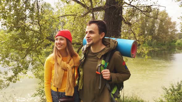 Active Young Couple of Tourists Enjoying the View Looking at the Mountain Forest Landscape Travel