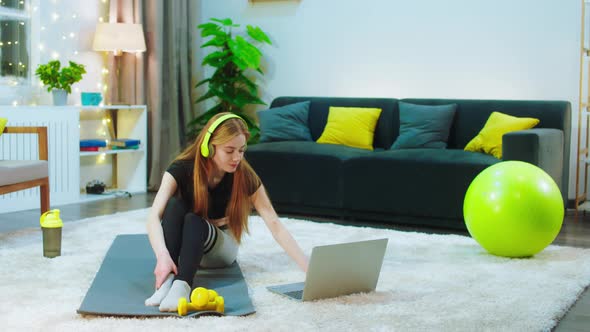 A Woman with Ginger Hair Is on the Floor Sitting