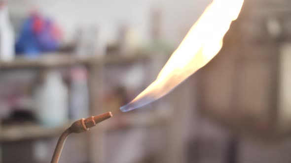 Lighting propane torch with lighter. Flame close up