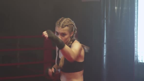 Female Fighter Trains His Punches Training in the Boxing Gym the Girl Trains a Series of Punches