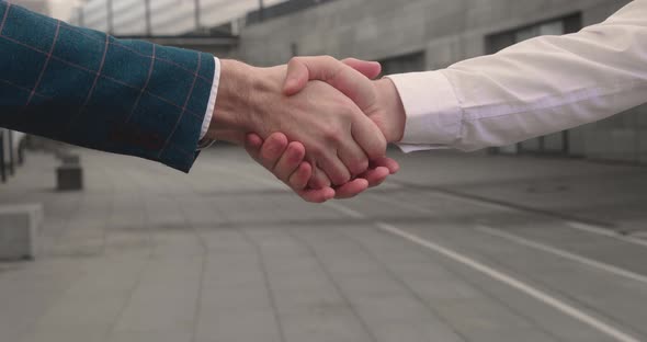 Two Men Shake Hands Conclude Successful Contract Agreement Sign of Support for Partnership
