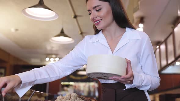 Chocolate Store. Female Seller In Confectionery Shop