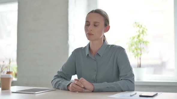 Tense Woman Feeling Frustrated While Sitting in Office