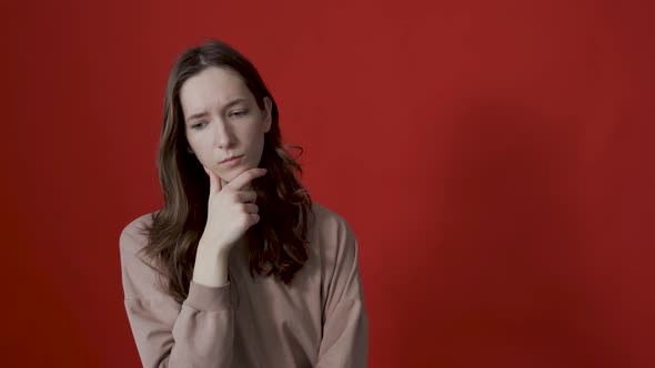 Portrait of a Thoughtful Young Woman with Long Hair Thinking Intensely Pondering a Solution to a