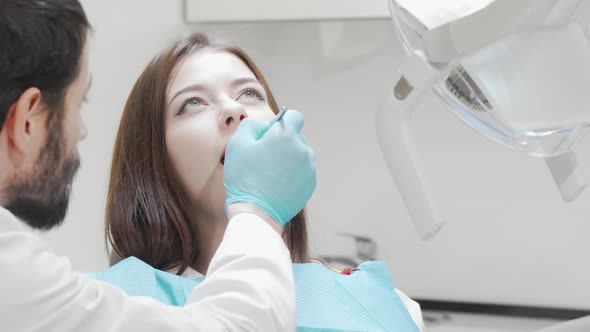 Happy Young Woman Smiling to the Camera After Dental Checkup