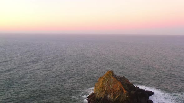 Oregon Coast sea stacks at dawn. Drone backwards reveal of beautiful sea stacks. Coast near Brooking