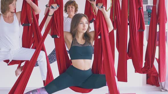 Women Group Enjoys Practicing Modern Fly Yoga Positions