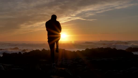 Slow Motion Men Warrior Dancer Practicing Silhouette Tai Chi Karate Kung Fu on the Rocky Stones