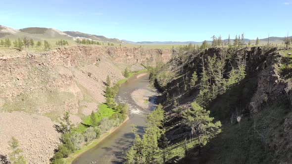 Broken Crumbled Rocks Spilling From the Narrow Canyon Slope Ridge Towards the Deep Valley Floor