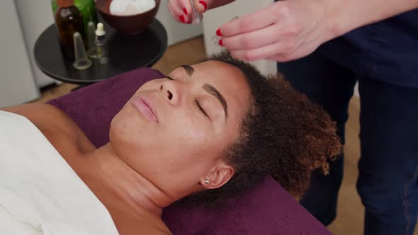 Therapist Applying Suction Vacuum Cups for Facial Massage Indoors