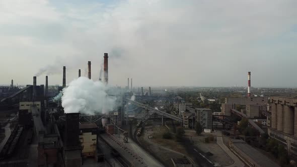 Aerial view over industrialized city with air atmosphere and river water .