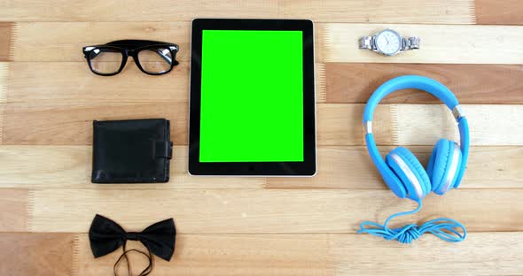 Digital tablet, headphones, wallet, spectacles, wrist watch and bowtie
