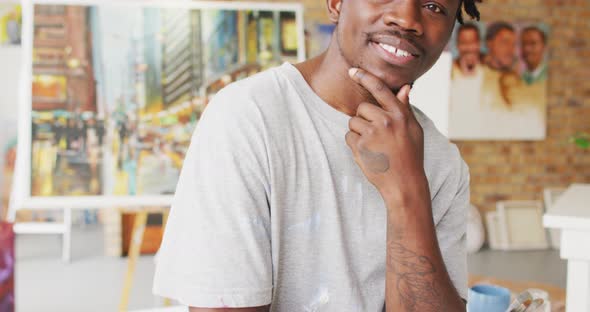 Portrait of smiling african american male painter in artist studio