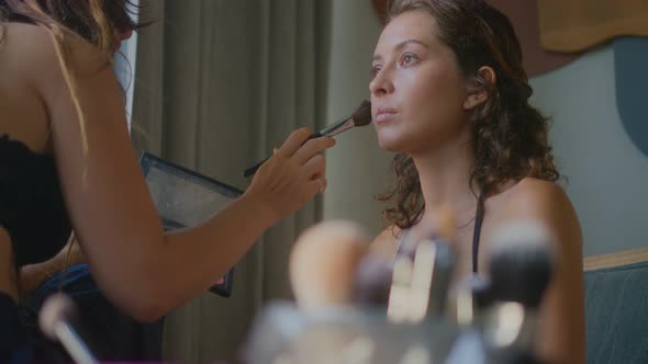A Makeup Artist Makes a Bright Makeup for a Beautiful Girl Model