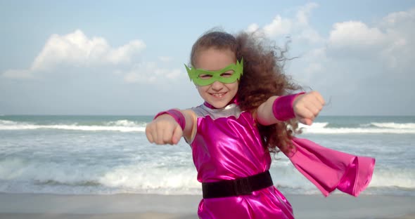 Baby Girl Plays a Superhero Makes Flight Movements Flies Forward with His Hand Raised Forward