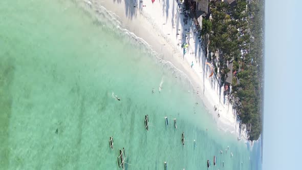 Vertical Video Kitesurfing Near the Shore of Zanzibar Tanzania Aerial View