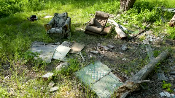 Remains of old furniture near abandoned old buildings