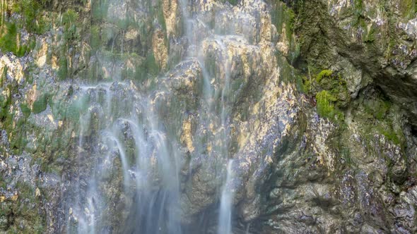 Waterfall background with green moss