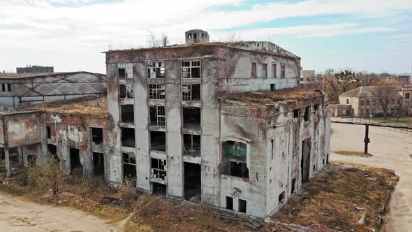 Flight over the destroyed factory. Old industrial building for demolition. Aerial view