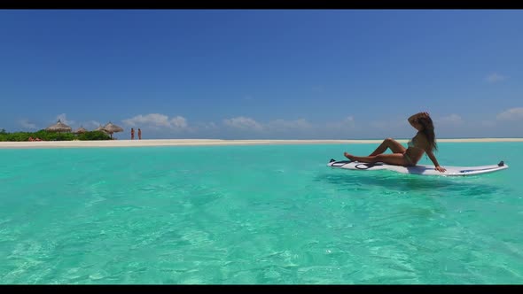 Women sunbathing on paradise sea view beach break by transparent sea and white sand background of th