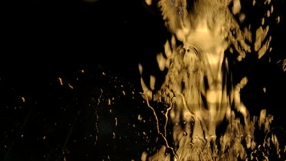 Strong Rain Water Flushes Against Window Glass and Streaming Down on a Black Background. Beautiful