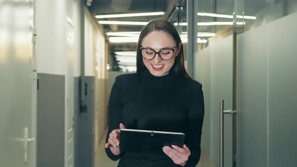 Portrait of a Successful Businesswoman with Glasses Looking Into the Camera of European Appearance