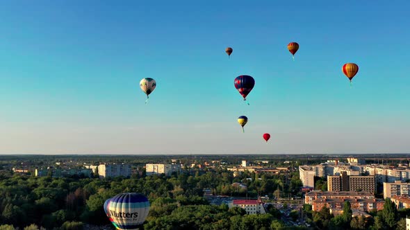 Beautiful balloons fly over the forest, park, city. Beautiful evening balloon flight.