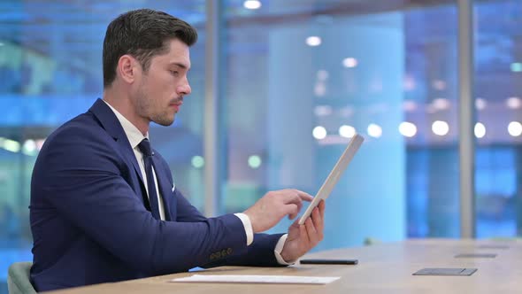 Businessman Disappointed By Loss on Tablet