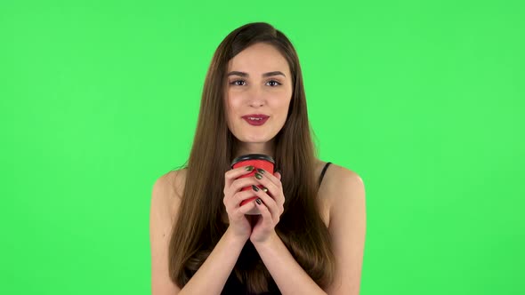 Cheerful Young Woman Enjoying Coffee on Green Screen