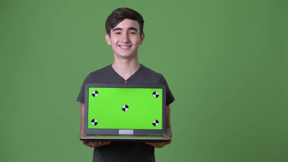 Young Handsome Iranian Teenage Boy Against Green Background