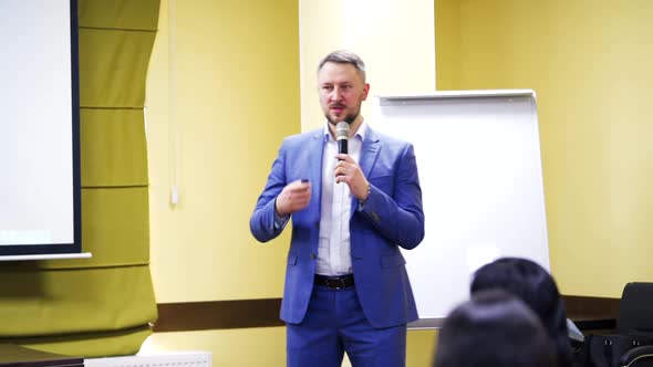 Businessman in elegant suit explaining the lecture in the conference room.