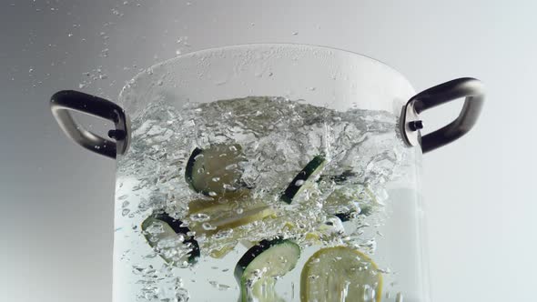 Throwing zucchini into boiled water. Slow Motion.