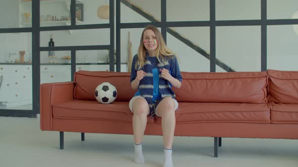 Excited Female Football Supporter Watching Game on Tv and Celebrating Goal