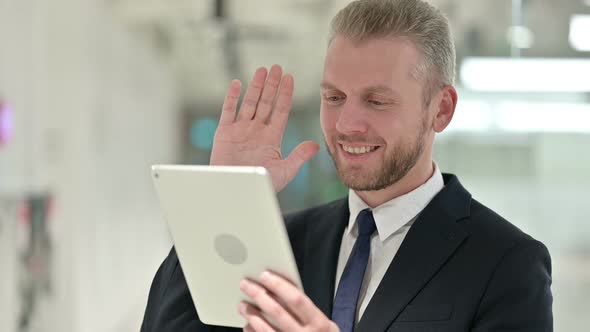 Portrait of Businessman Doing Video Call on Digital Tablet 