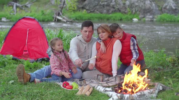 Family Spending Time Near Campfire