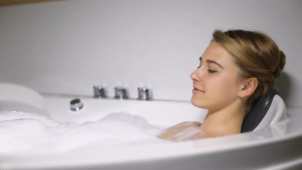 Relaxed Female Enjoying Massaging Bath With Foam Bubbles, Spa and Wellness