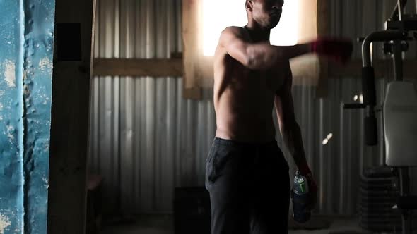 Boxer drinking water in the gym