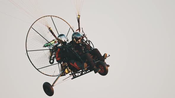 Tandem Paramotor Gliding - Two Men Flying and Gliding in the Air