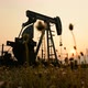 pumpjack at an oil drilling site and sunset - VideoHive Item for Sale