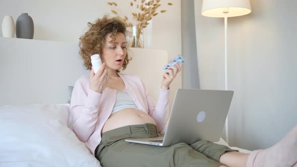 Pregnant Woman Consult A Doctor Online Using Laptop.