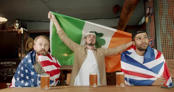 Fans Watching Football in a Bar with Friends