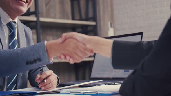 Asian businessman shaking hands partnership deal business.