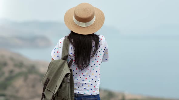 Back View Woman in Straw Hat Admiring Beautiful Natural Seascape