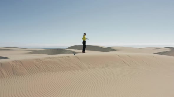 Futuristic Woman Fighting and Shooting in AR Glasses Outdoors in Sand Dunes