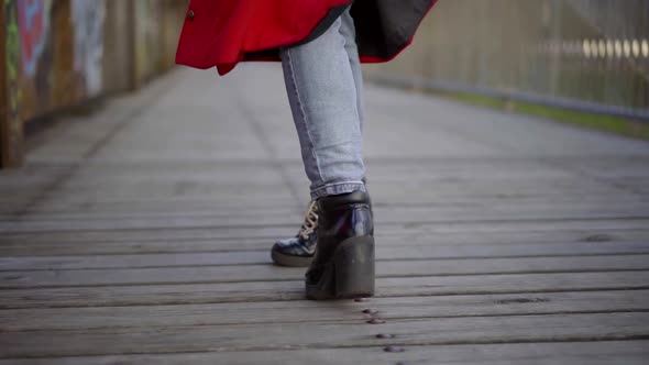 Townswoman Is Walking Alone on Wooden Bridge in Autumn Day, Closeup of Feet