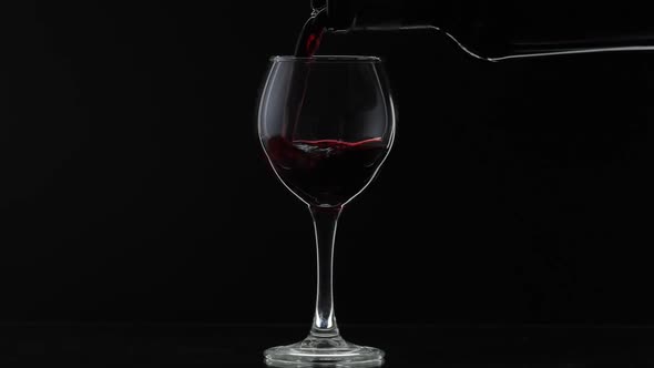 Rose Wine, Red Wine Pour in Wine Glass Over Black Background, Silhouette