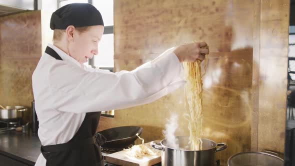 Chef putting the pasta in boiling water